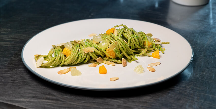 Plate of whole wheat spaghetti with citrus pesto