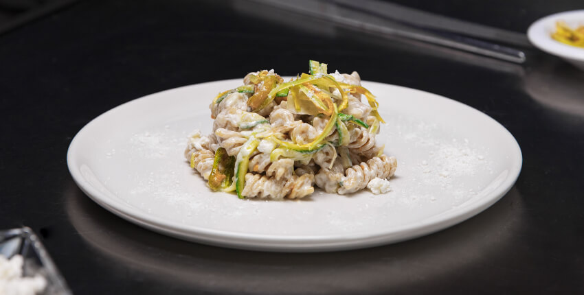 Plate of wholewheat Fusilli with eggplant, with goat cheese and pumpkin seed oil