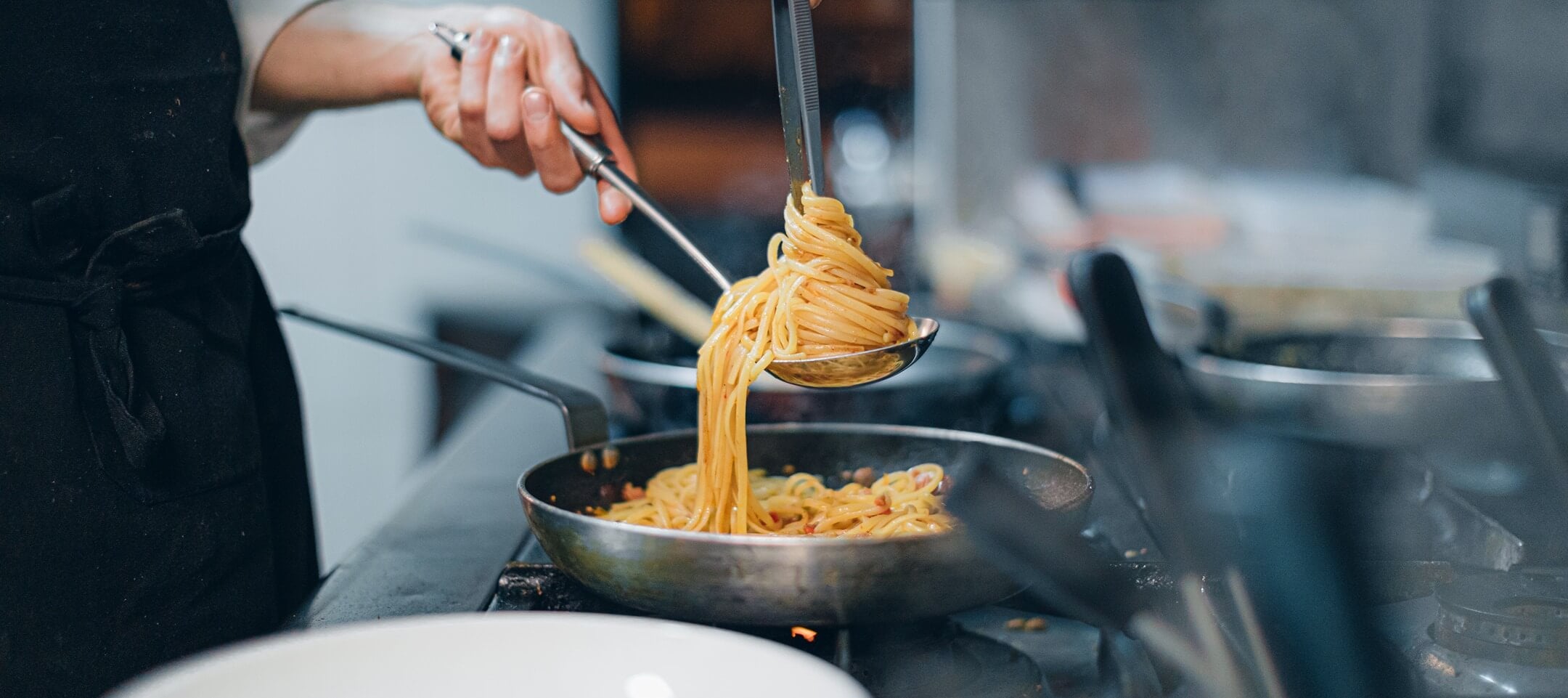 Chef Plating Spaghetti in the Kitchen